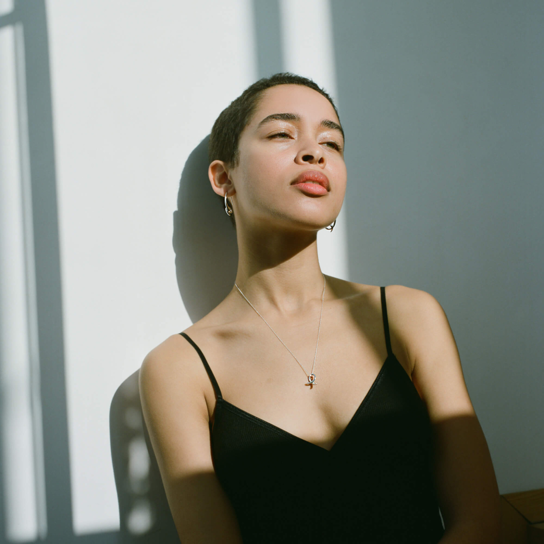 Female model in black showcasing contemporary jewellery