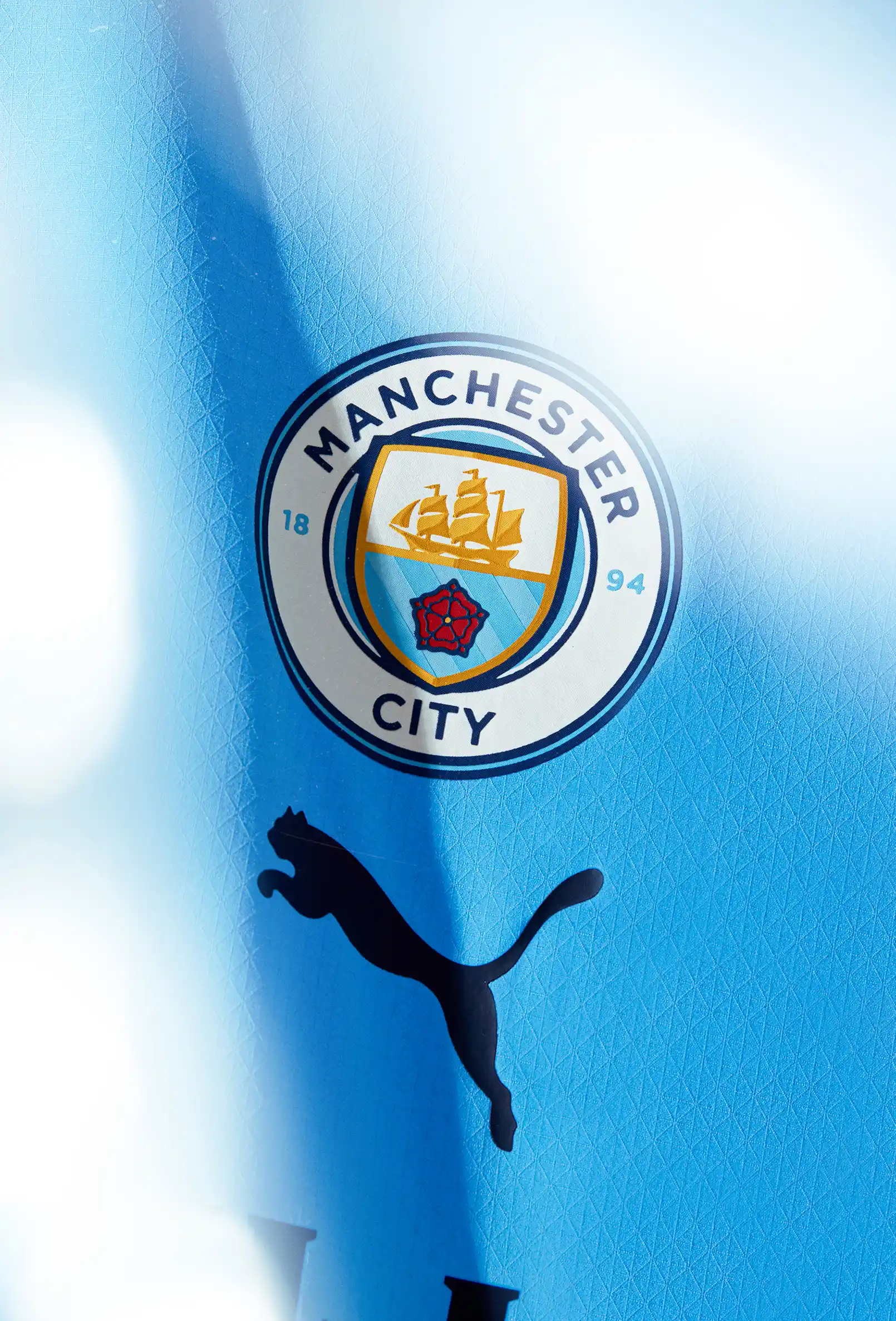 packshot-stilllife-man-city-shirt-badge-closeup-nov25